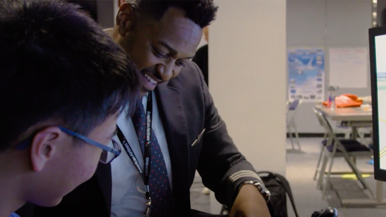 Quincy with a student in a classroom.