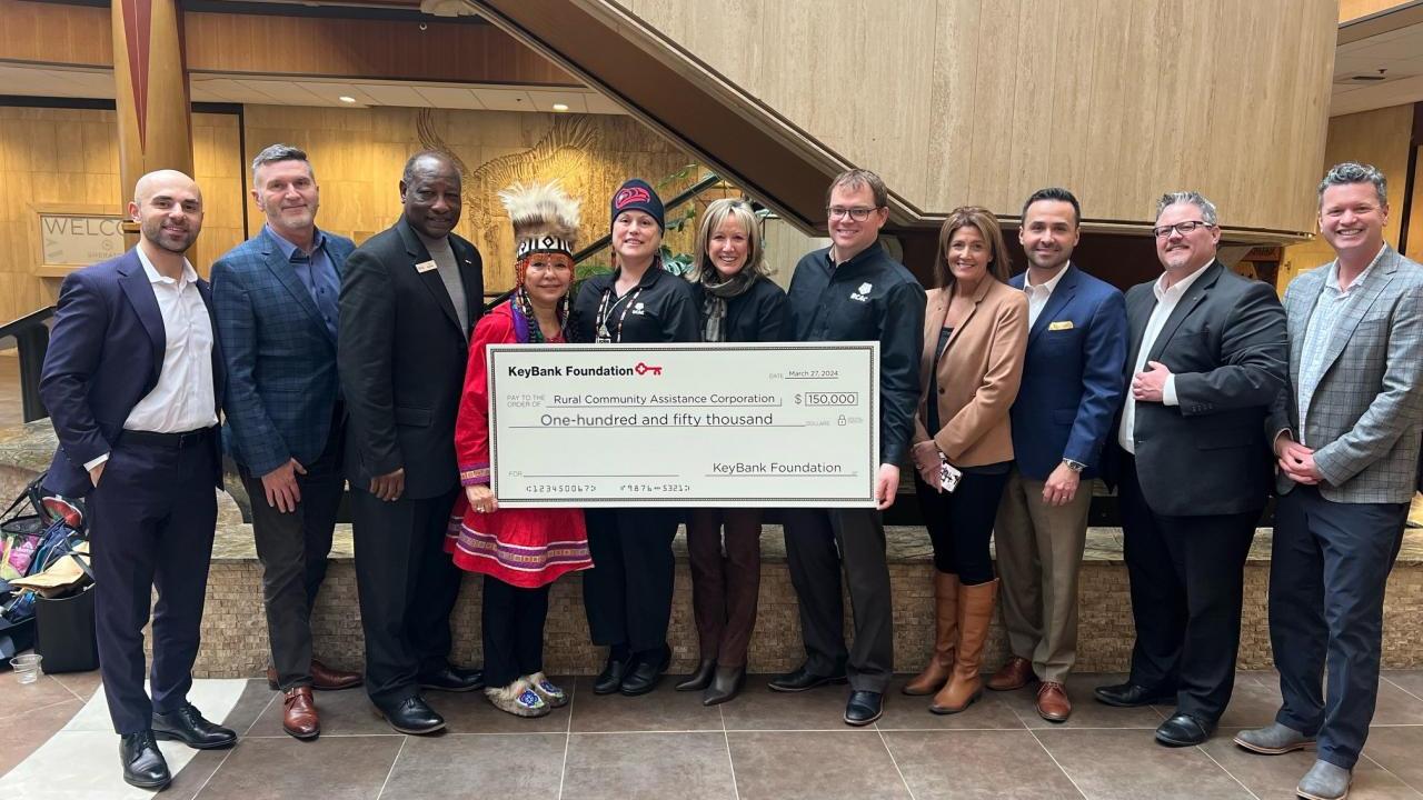 A group of people holding a large cheque 