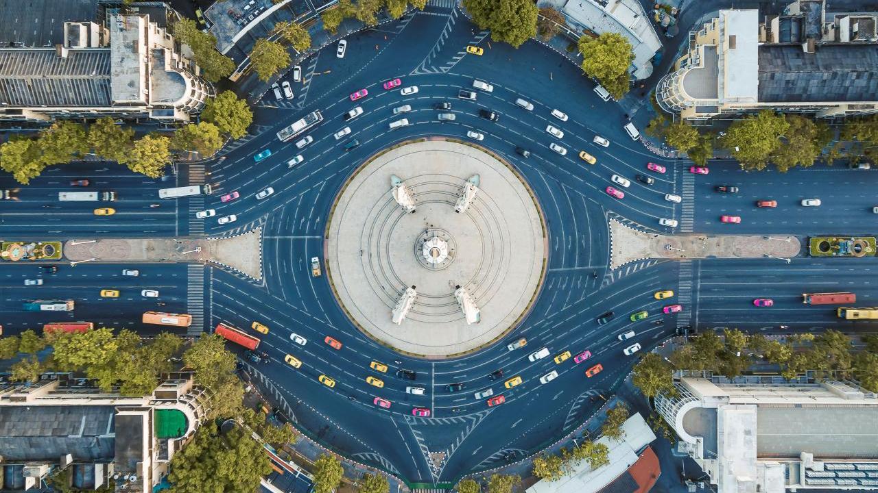 Aerial view of a busy roundabout in a city setting.