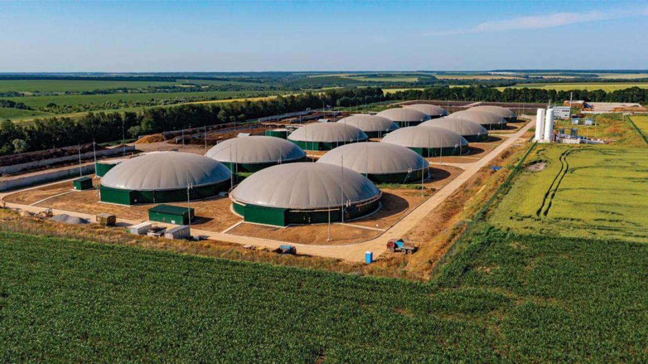 Aerial view of roes of domed buildings surrounded by farm fields.