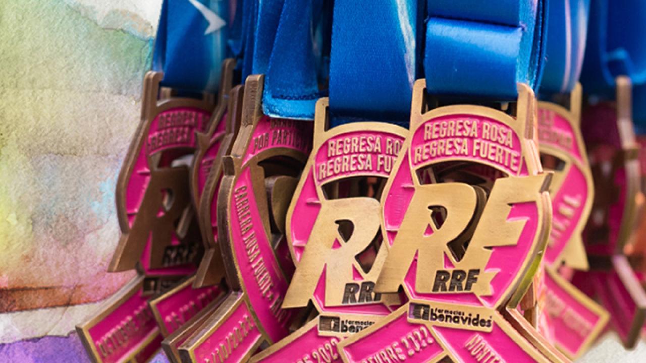 Many award medals in a bunch. RRF logo and pink ribbon medallion.