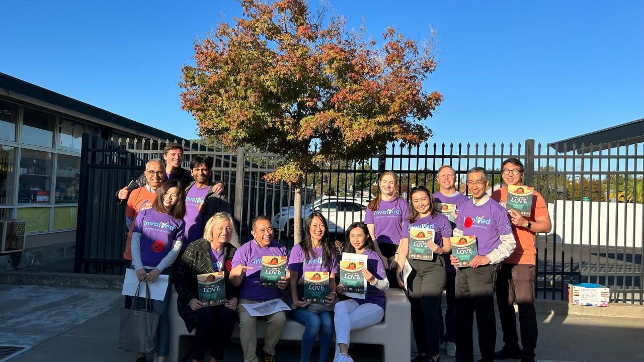 San Mateo volunteers holding up books