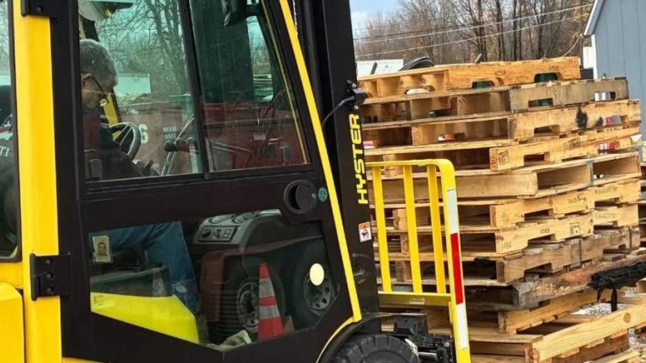 Forklift moving wooden pallets