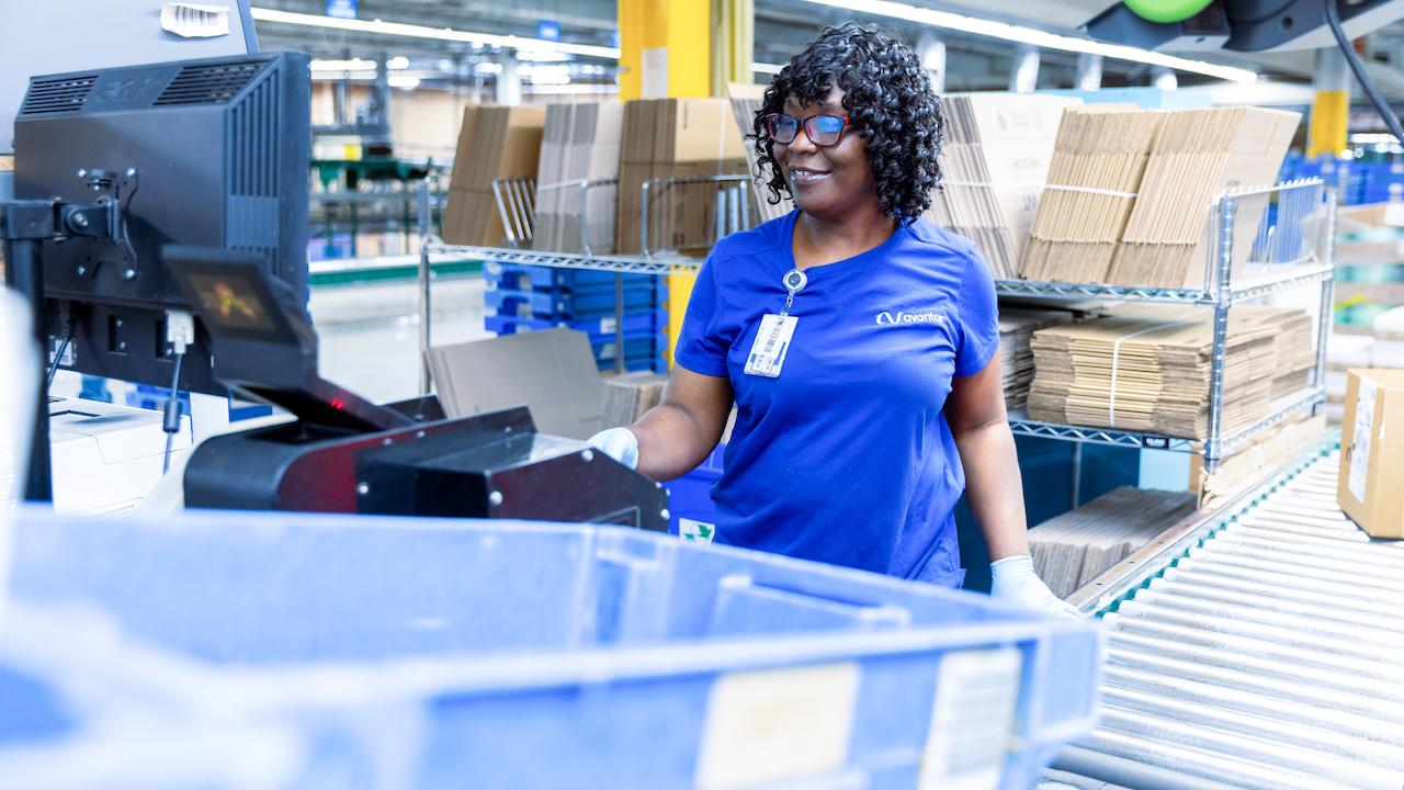 A female working in the packaging area of the Avantor warehouse.