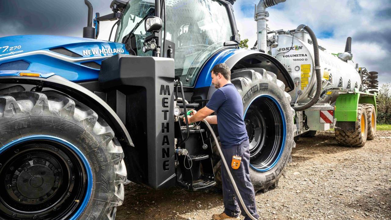 A person refueling a tractor