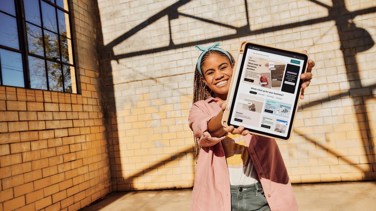 Young person holding a tablet. 