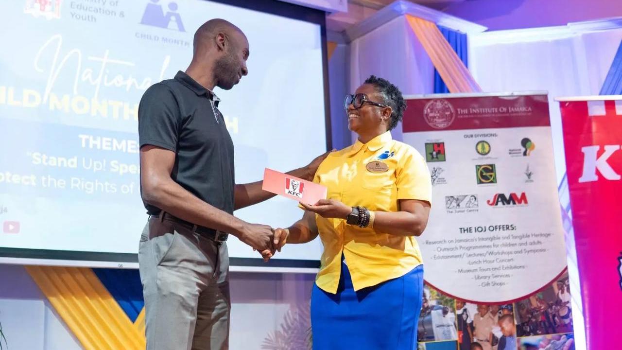 Restaurants of Jamaica Brand Manager Andrei Roper (left) presents a symbolic cheque to National Child Month Committee Chairperson Nicole Patrick-Shaw, during the National Child Month Launch.