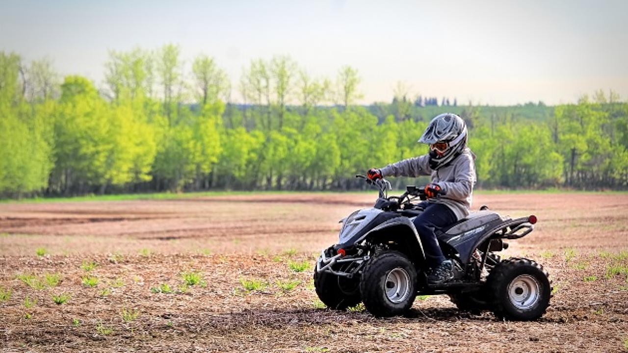 A person on an ATV on dirt terrain.