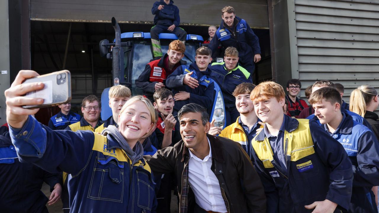 UK Prime Minister, Rishi Sunak, taking a photo with New Holland engineering apprentices 