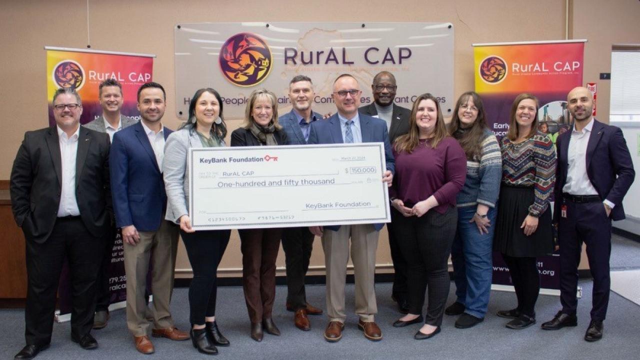 RurAl Cap and KeyBank representatives shown with a $150,000 grant check.