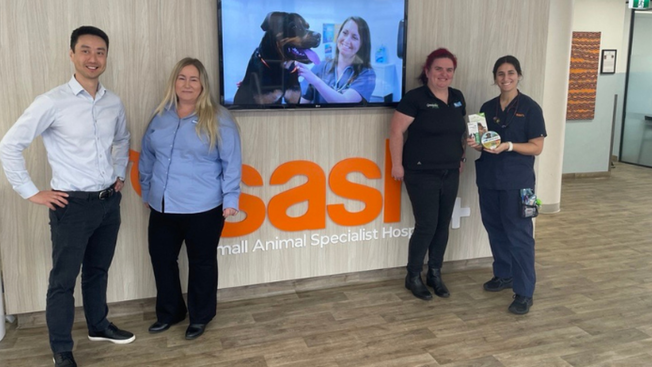 Four people standing by SASH sign 