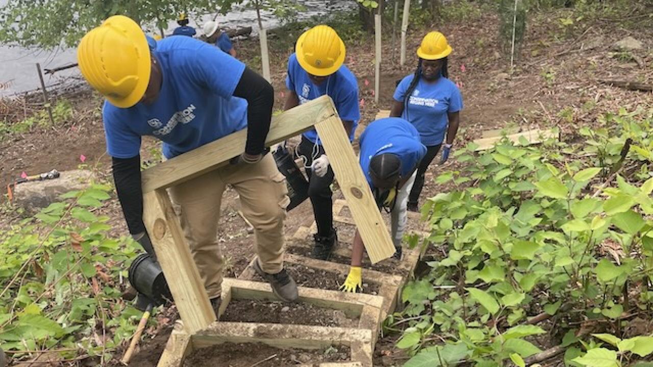 SCA Team members working on steps in a park.