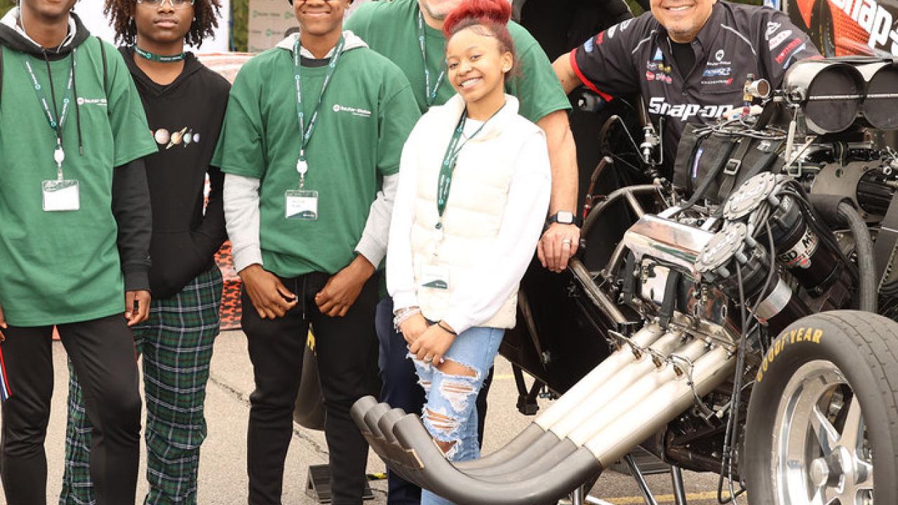 Students pose with Cruz Pedregon and his 'Nitro Funny Car'