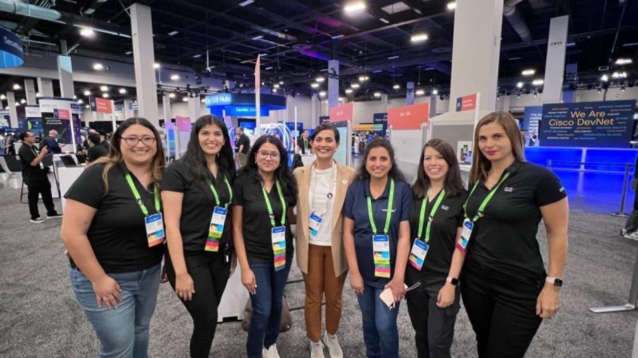 A group posed in an open exhibit hall.