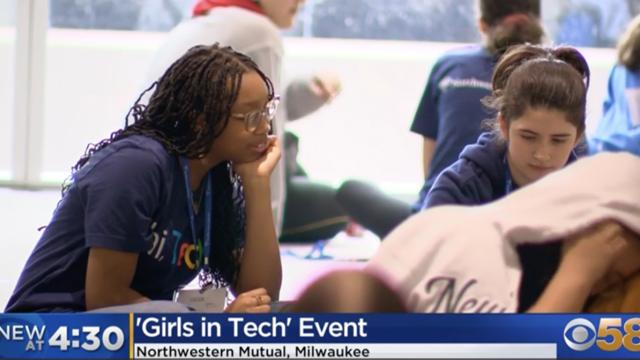 Young women in lanyards working together at a group event