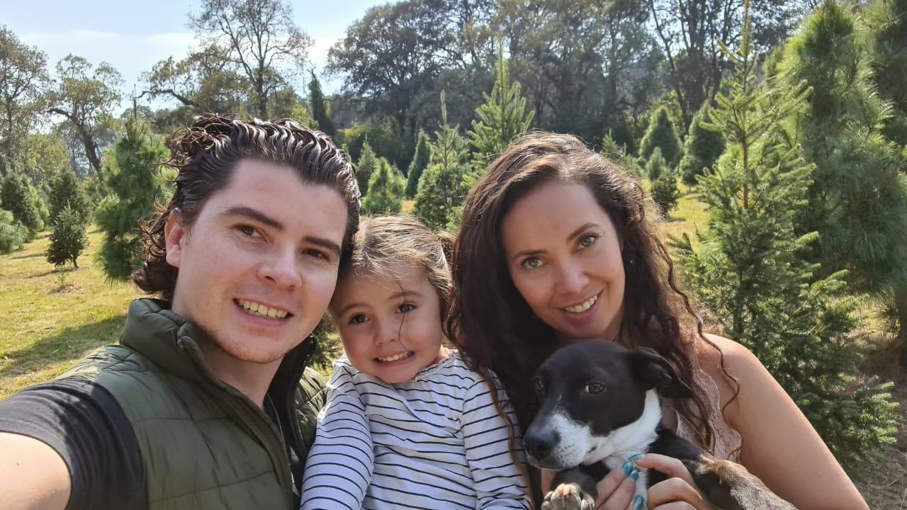Man and woman holding daughter and dog
