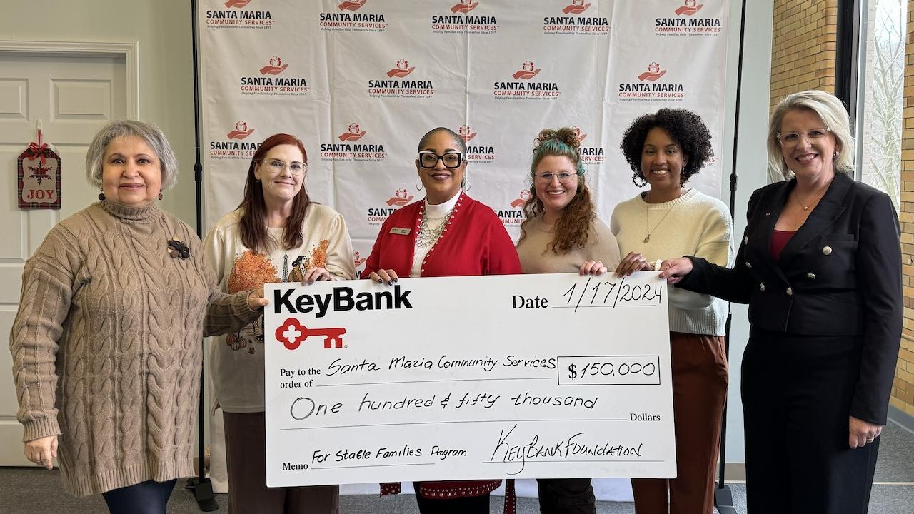 Representatives from KeyBank and Santa Maria Community Services shown with a $150,000 grant check.