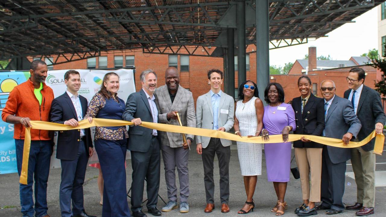 Group of people at ribbon cutting celebration for the completion of the solar array at Sargent Memorial Presbyterian Church