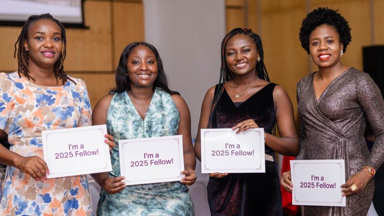Four people holding signs that read I'm a 2025 Fellow!