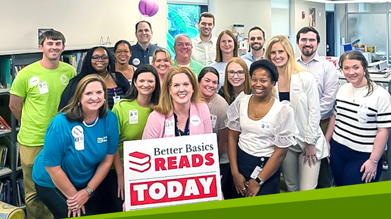 Group photo in front of sign that reads "Better Basics READS TODAY"
