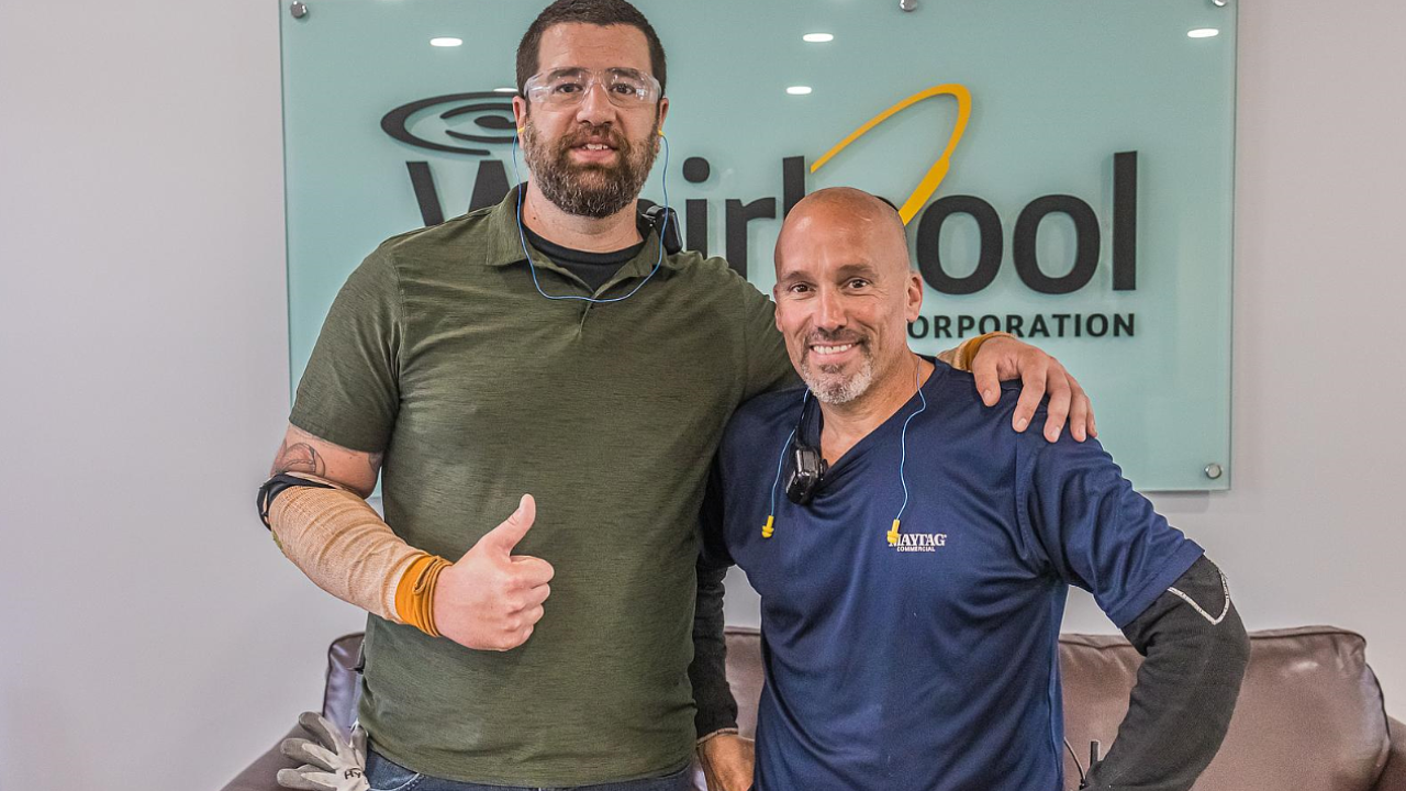 Scott Cabral and co worker in front of a whirlpool sign