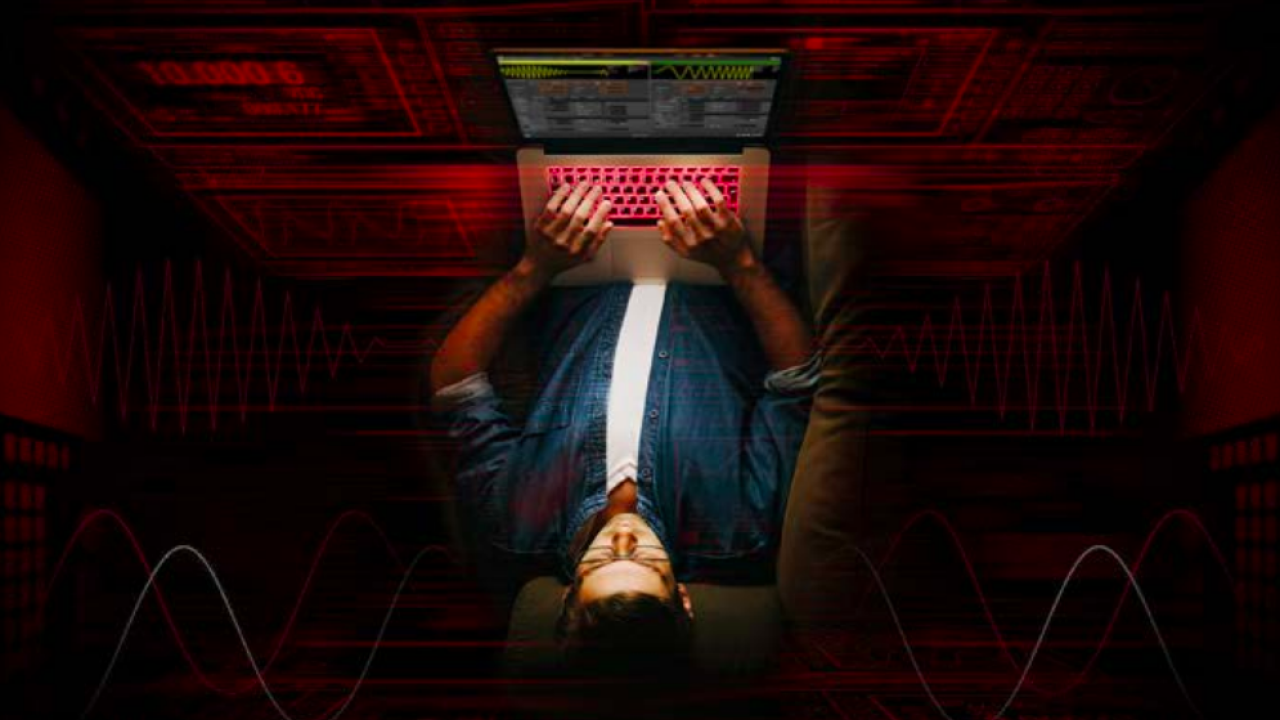 Aerial view of man typing on a laptop