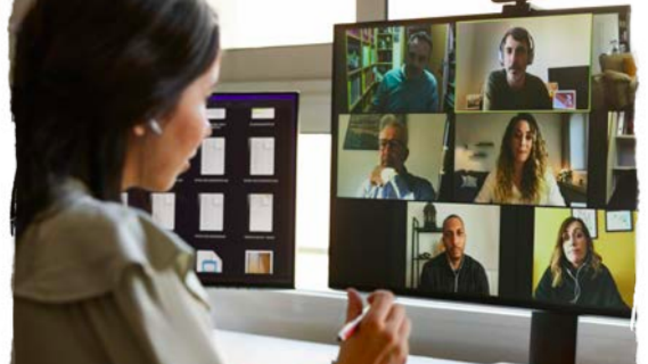 a woman looking at her computer screen on a video call