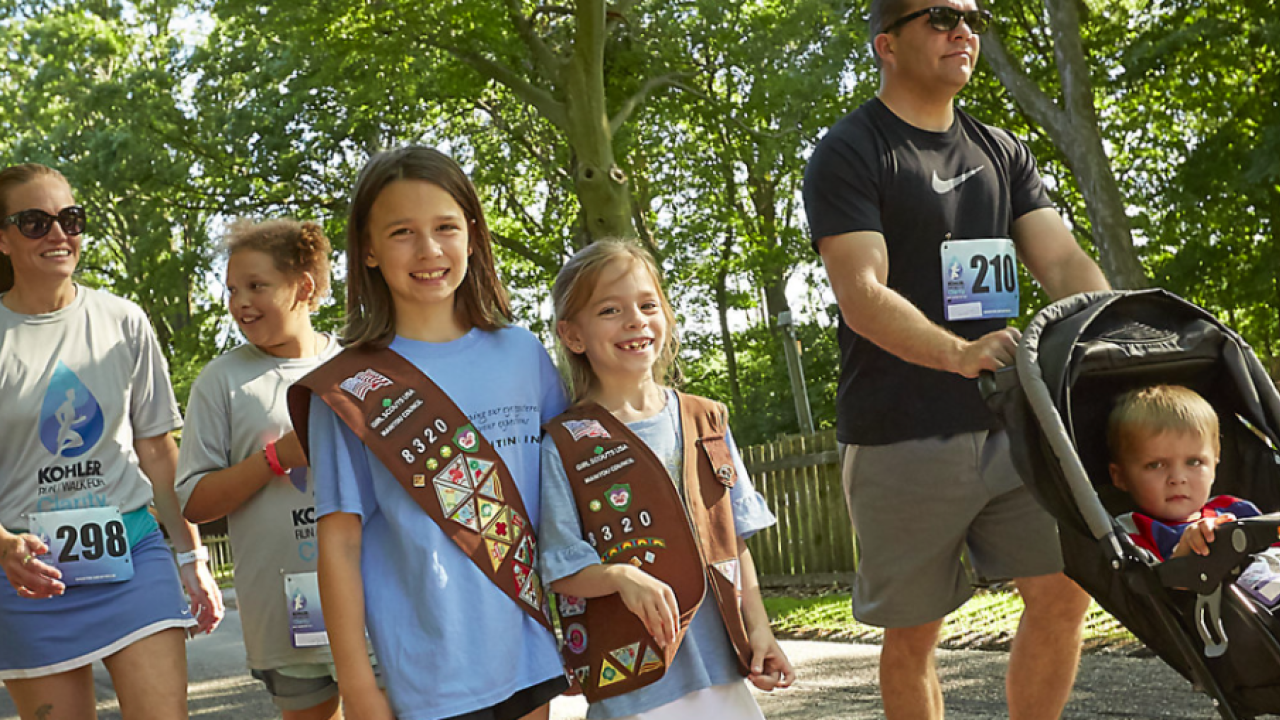 Group of people smiling and walking