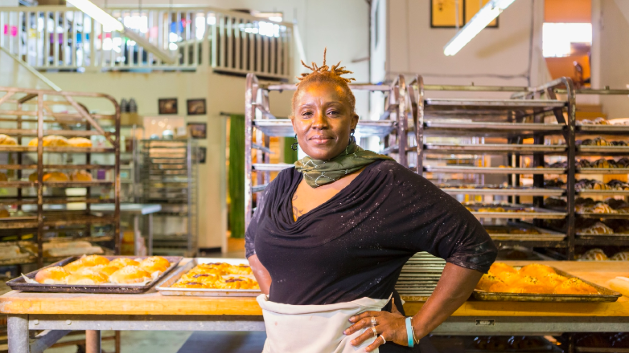 a baker standing in a bakery