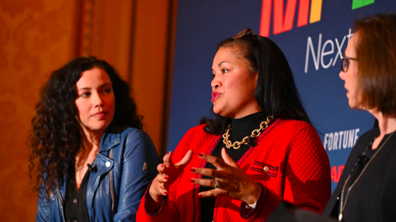 Three women speaking on a panel