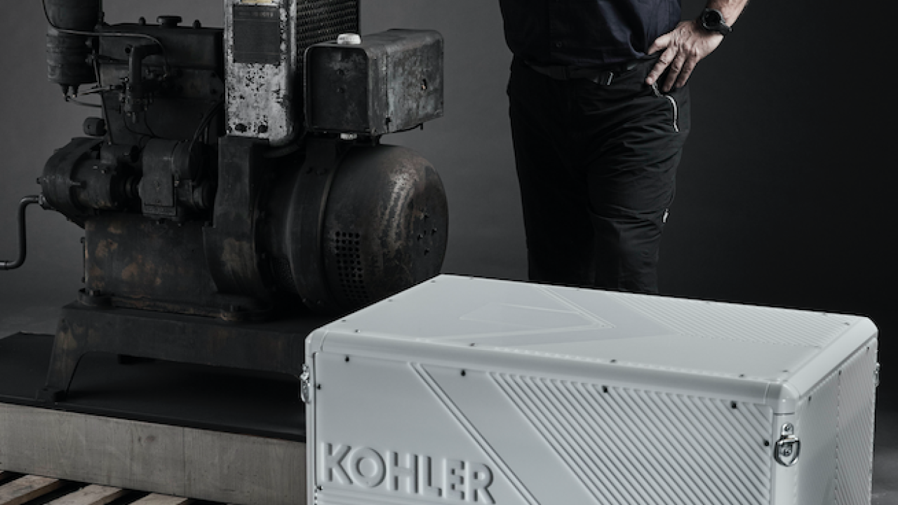 Robert Swan standing behind Kohler-branded engine