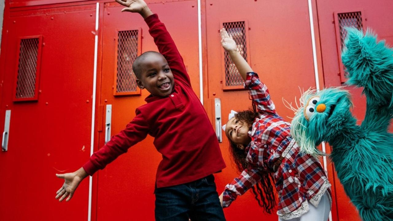 Kids dancing with Sesame Street character