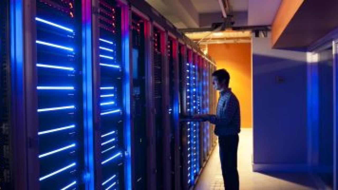 Person standing at a server rack