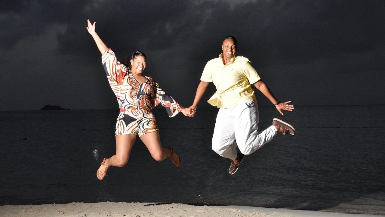 Shae (right) and her wife, Taralyn (left), jumping in the air