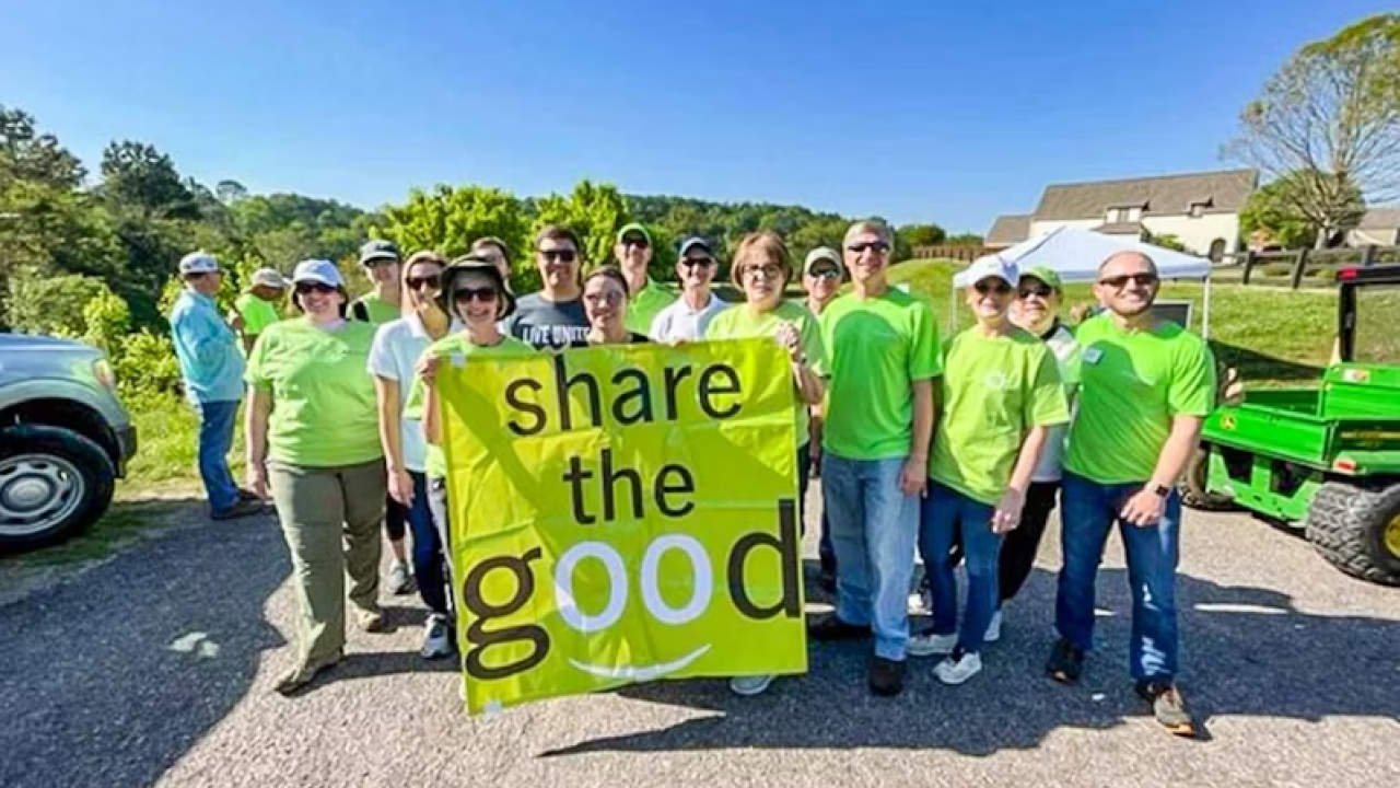 Volunteers with a share the good banner