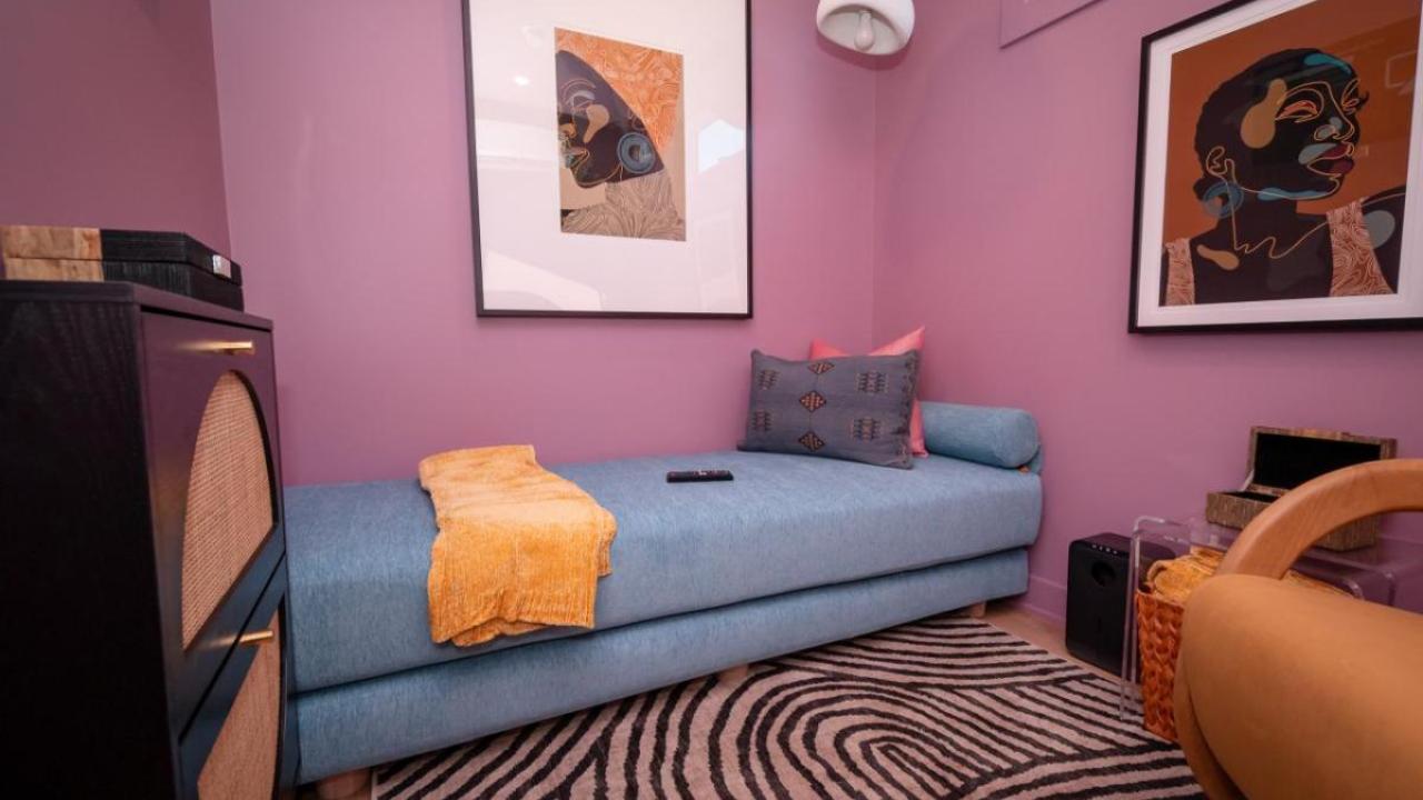 Photo of a SheCare Wellness Pod with a couch, easy chair and art on the walls.
