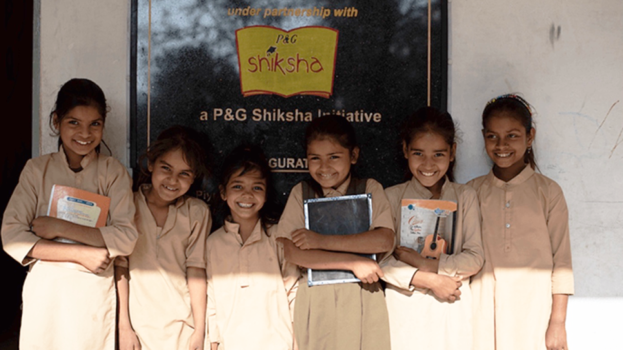 school girls in front of sign