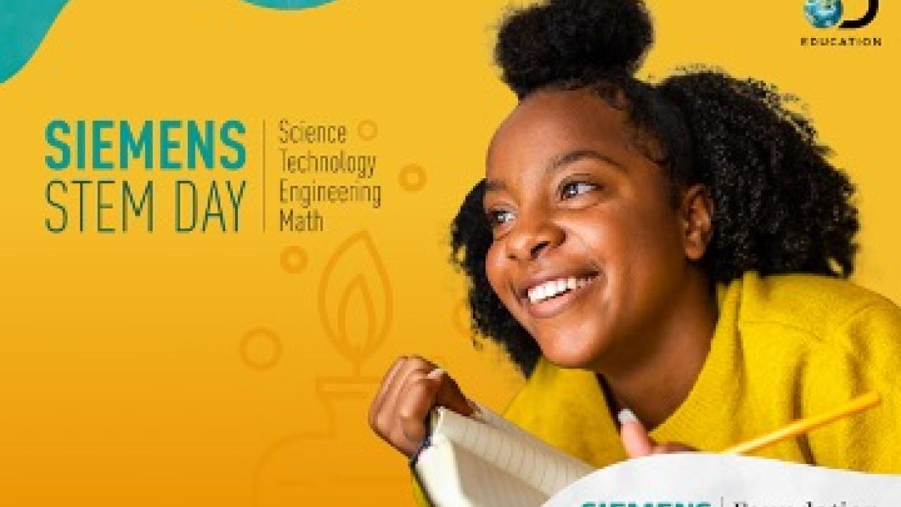 Smiling student holding a book with Discovery Educaton and Siemens Foundation logos
