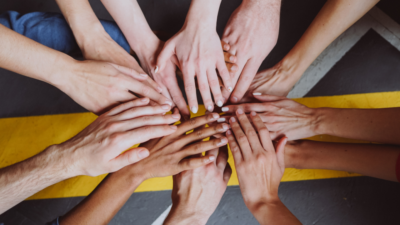 Multiple hands coalescing to portray diversity and inclusion