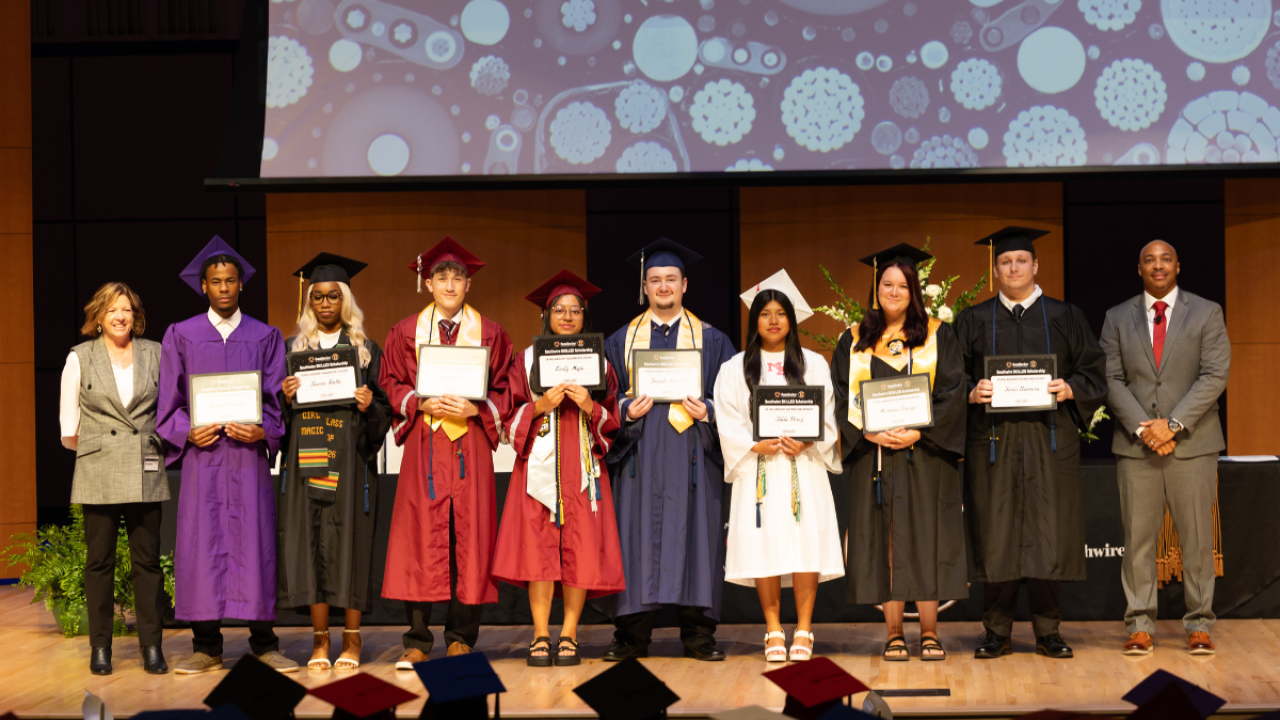12 for Life students at graduation holding certificates