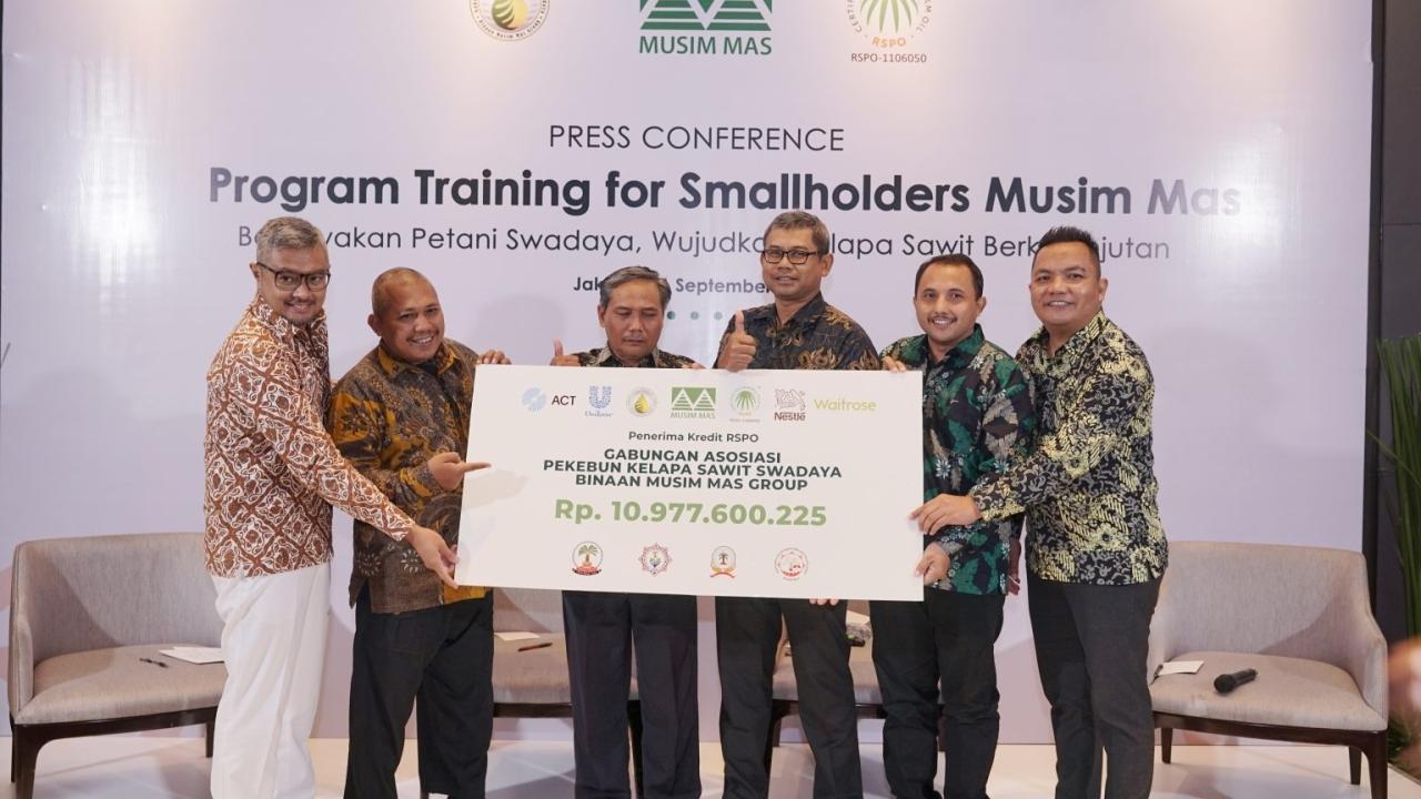 smallholders holding up check