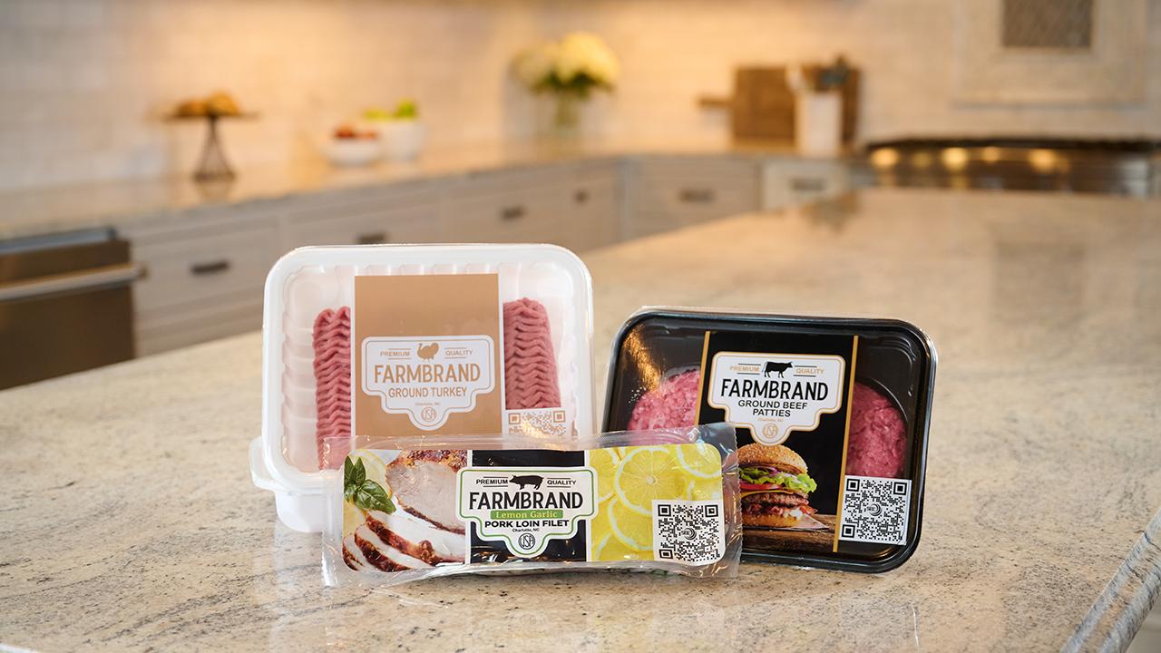 Three packages of fresh meat sitting on a kitchen counter