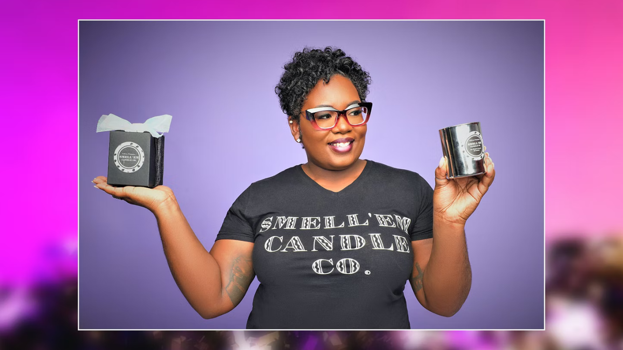 Shantell Jennings wearing a  Smell’em Candle Company t-shirt and holding her candles