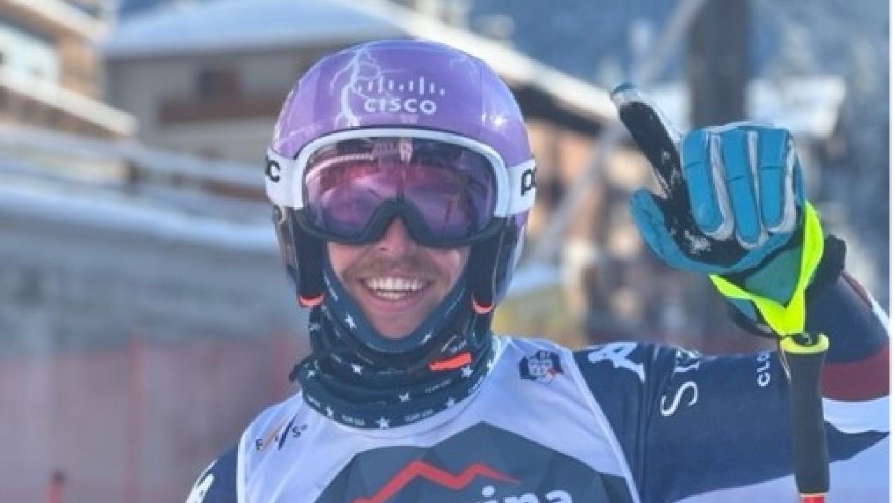 Spencer Wood in ski attire, waving at the camera