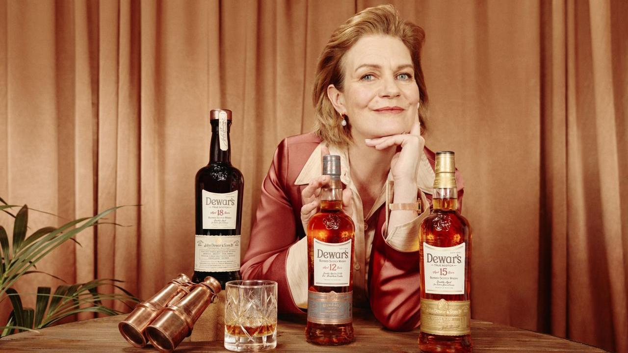 Stephanie Macleod sitting with DEWAR whisky bottles