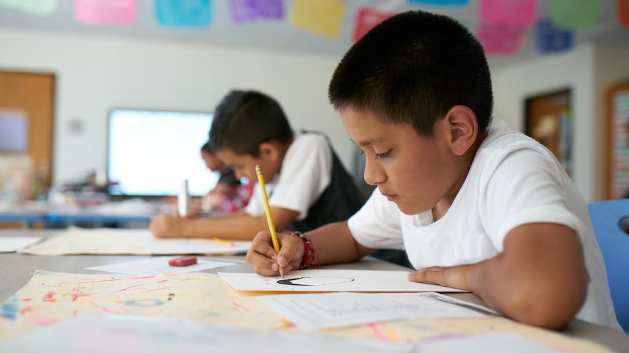 students writing in classroom