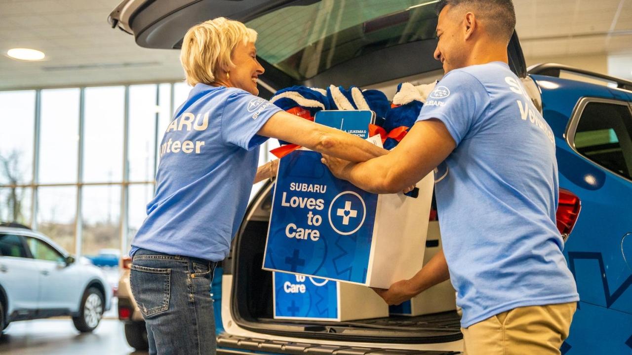 Subaru employees loading supplies into car