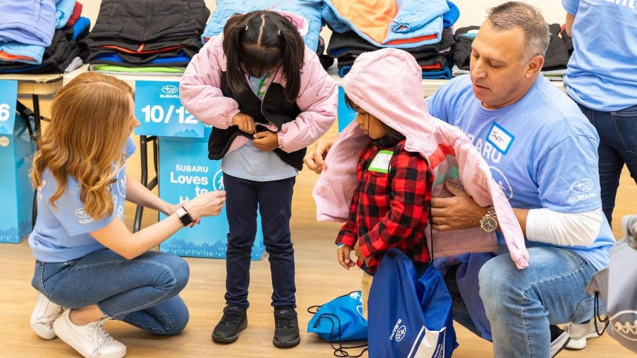 Children trying on jackets