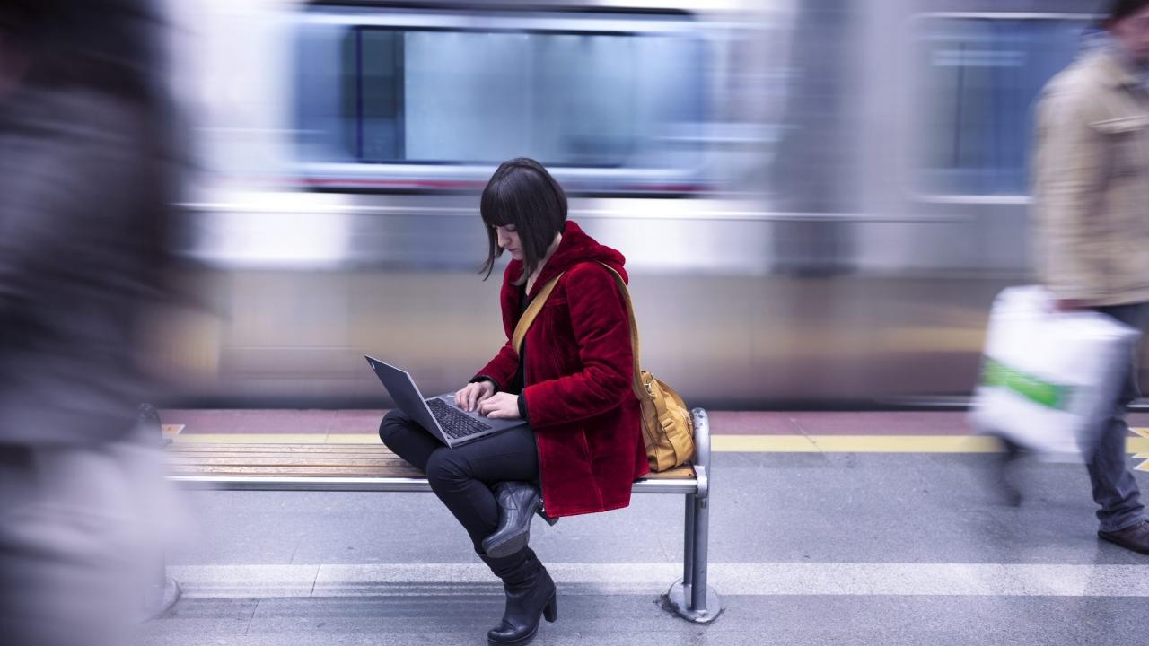 a person in a subway station working on a laptop