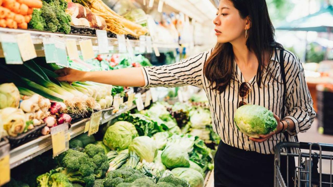 Picking produce at grocery store